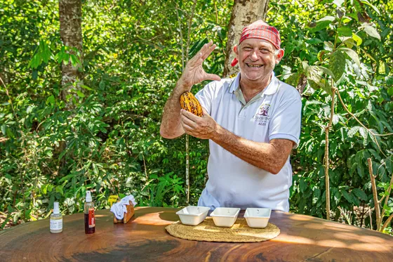 Guide holding a fresh cacao pod on a Costa Rica chocolate tour near Bella Vista