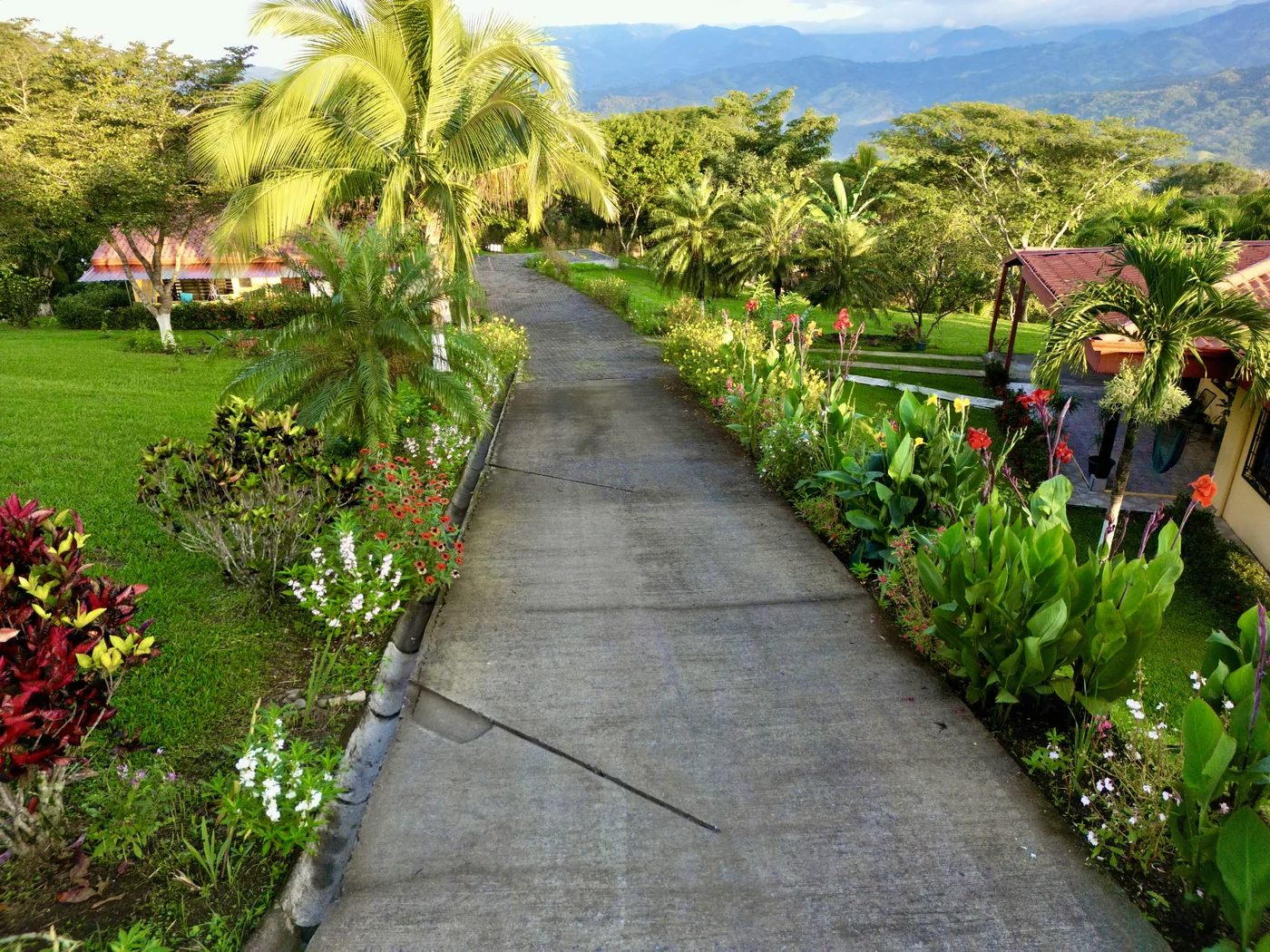 Lush flower-lined gardens and mountain views at Bella Vista Private Resort during Costa Rica's green season