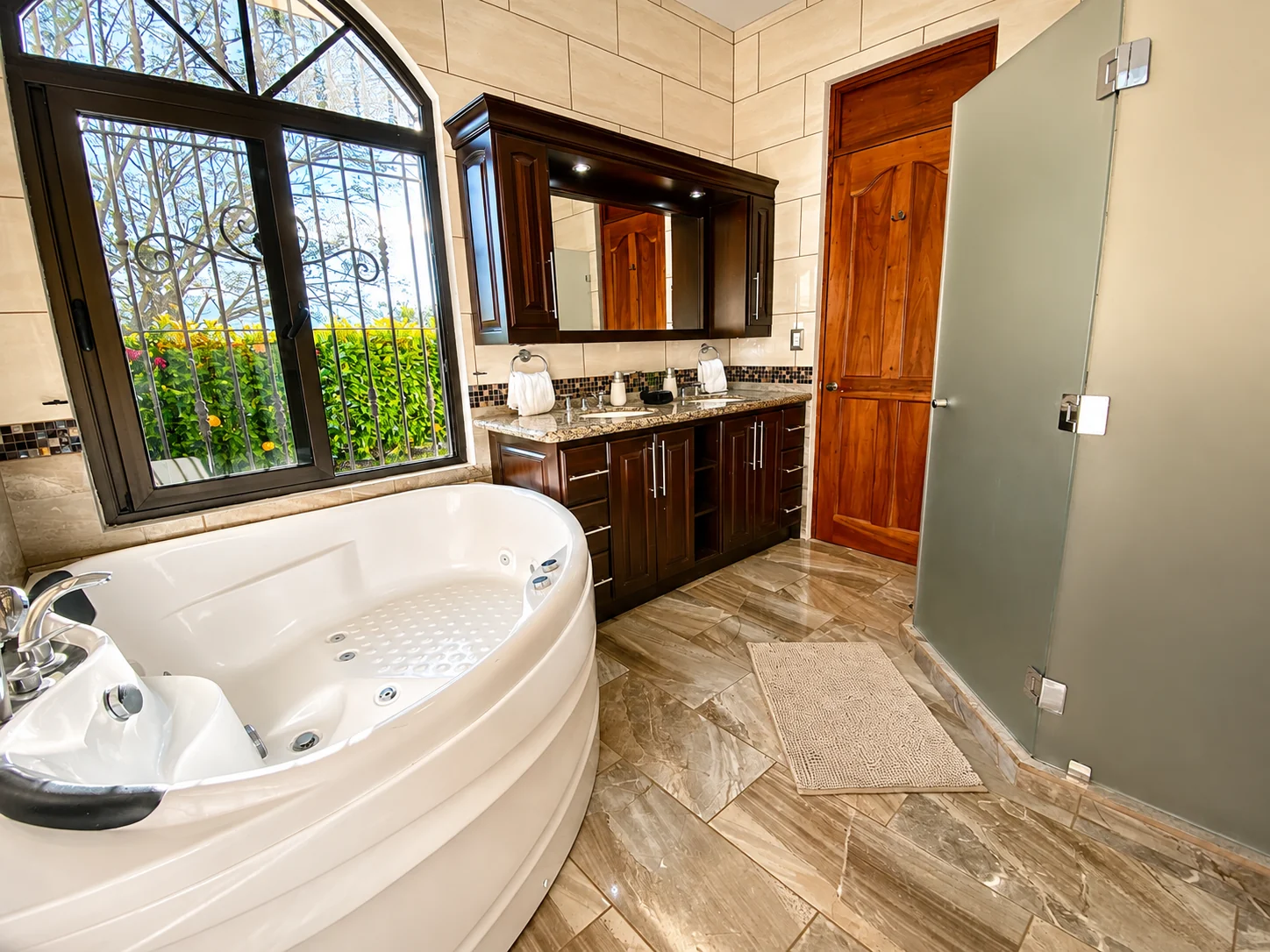 Main House Bedroom 1 en-suite master bathroom with soaking tub and shower at Bella Vista Costa Rica