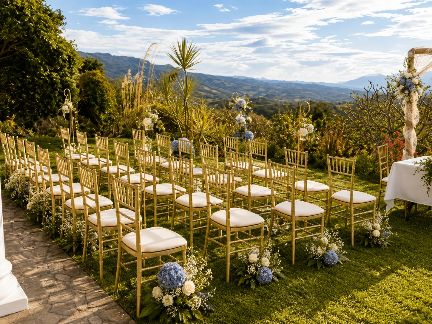 Wedding ceremony set up on the South Lawn at Bella Vista Costa Rica, with gold chairs facing panoramic Central Valley mountain views